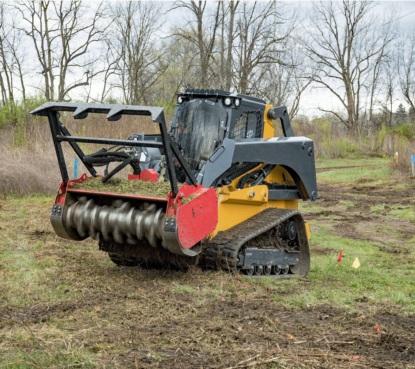 Forestry mulcher on grassy terrain.